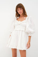 Sweet and irresistible ~ Introducing the Tiana Mini Dress from For Love & Lemons. Self: 100% Cotton; Embroidery: 100% Polyester; Lining: 100% Cotton   Rose eyelet Halter ties Rosettes details Ruffle trim details Gathered waistline Long puff sleeves Invisible zip closure Eco Dry Clean recommended. Avoid cleaners that use harmful chemicals like "perc".