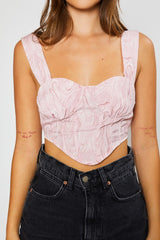Strawberry swirl, you'll be making them twirl in our precious bustier crop top! Its' flattering bustier style silhouette will perfectly compliment any of your high rise denim, and its' smocked back ensures this number is as comfortable as it is cute!  Runs true to size, model wearing size small 100% Polyester Cropped length Partially lined