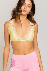 Truly a work of art, and you'll be a work of art in it...this lace halter racerback bralette is as stunning as it is practical. Featuring allover lace detailing that provides the perfect peek-a-boo to any tank, a sultry halter neckline and flattering and supportive racerback with lace detailing, this will be a new favorite in your intimates drawer! Runs true to size, model wearing size small 94% Rayon, 6% Spandex Adjustable strap at back Partially lined