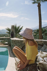 Made from 100% cotton canvas with a violet floral print, our new wide-brimmed holiday bucket is finished with a simple and secure necktie, ensuring this hat goes everywhere you do.