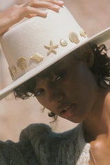 Chic to the core and now available as our limited edition ‘Summer of Sun’ hat. Featuring our classic ivory dipped boater silhouette with custom made gold Lack of Color seaside conchos. Unforgettable. Always wearable.