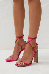 The Toniro by Billini is strappy high block heel. A go-to for any occasion, this strappy stiletto works for weddings, formals, parties and more!  Runs true to size Heel height 10.5cm. High shaved block heel Open square toe with thin, tubular toe strap Wrap around lace up ankle fastening Statement knot detailing Exposed heel counter Synthetic lining and outsole
