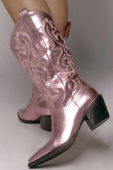 The boot of the season has arrived, and these metallic beauties are made for way more than just walking! The Danilo by Billini is a long western boot that gives the perfect touch of western inspired styling to your everyday, festival, or game day look!   If in between sizes, we recommend sizing up Heel height 7 cm Low stacked block heel Closed pointed toe Structured upper Western inspired embroidery Oversized side pull tabs for a pull on design Synthetic upper, lining and outsole