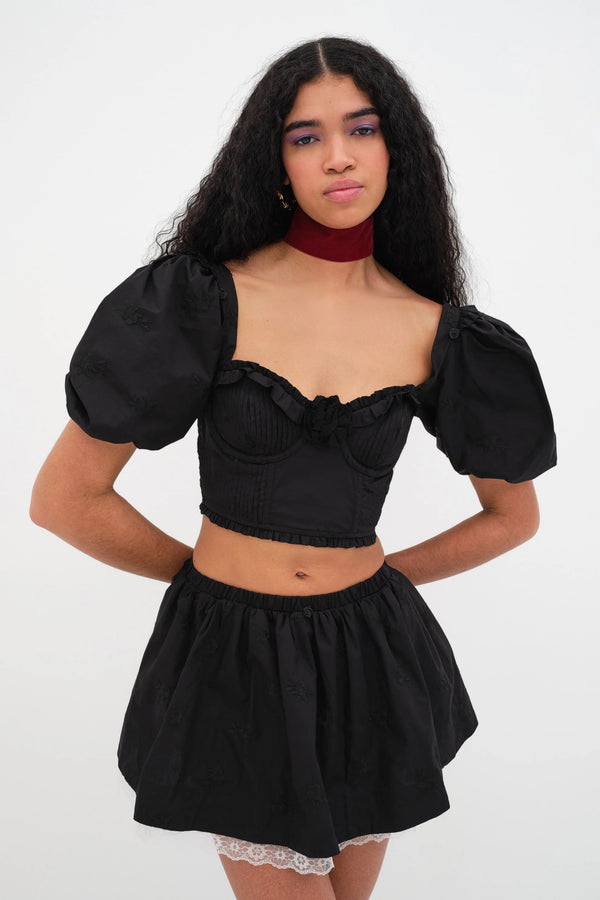 Fall attire. Introducing the Maye Crop Top from For Love & Lemons. Self: 100% Cotton; Embroidery: 100% Polyester; Lining: 100% Cotton    Rose embroidery Pin-tucked underwire cups Rosette at center front Puff sleeves Ruffle details Hook & eye closure Eco Dry Clean recommended. Avoid cleaners that use harmful chemicals like "perc".
