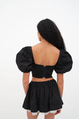 Fall attire. Introducing the Maye Crop Top from For Love & Lemons. Self: 100% Cotton; Embroidery: 100% Polyester; Lining: 100% Cotton    Rose embroidery Pin-tucked underwire cups Rosette at center front Puff sleeves Ruffle details Hook & eye closure Eco Dry Clean recommended. Avoid cleaners that use harmful chemicals like "perc".