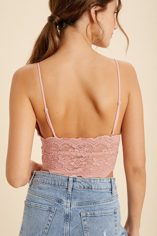 Little and lace and everything we love, this cami will be there for you when you're feelin' minimalistic. With removable padded cups, a V-neckline and unlined lace bodice, this stunner can be worn all by its' lonesome as a shirt, or wear it under a tee as a longline bralette.  Runs true to size, model wearing size small Self: 90% Nylon, 10% Sapndex; Lining: 95% Nylon, 5% Spandex Adjustable straps Scalloped trim Removable pads