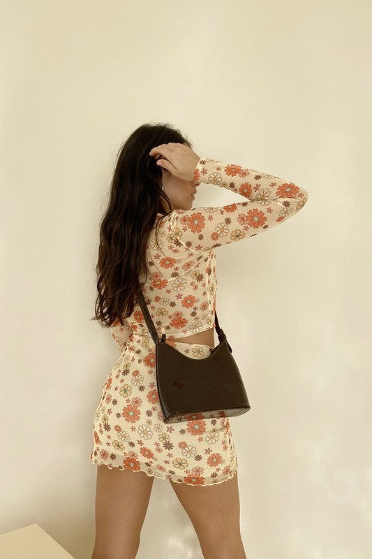 Take a dip in this precious mesh button down! Featuring functional buttons, a collar, and all over groovy daisy print, the styling potential for this gem is truly limitless. Complete the set with our Dippin' in Daisies Mesh Mini Skirt, wear it as a swim cover-up, or throw it on with your favorite denim!  Runs true to size, model wearing size small 95% Polyester, 5% Spandex Unlined Matching item available