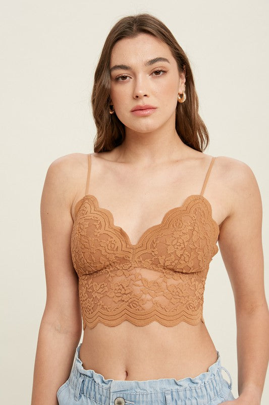 Little and lace and everything we love, this cami will be there for you when you're feelin' minimalistic. With removable padded cups, a V-neckline and unlined lace bodice, this stunner can be worn all by its' lonesome as a shirt, or wear it under a tee as a longline bralette.  Runs true to size, model wearing size small Self: 90% Nylon, 10% Sapndex; Lining: 95% Nylon, 5% Spandex Adjustable straps Scalloped trim Removable pads