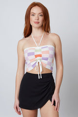 Check yes and add to cart immediately, this halter top is simply too good! With its' pastel checkered color palette, tube top halter silhouette, and functional ruching tie detail at the bust, this piece is the perfect pop of color to any mini skirt, jeans or denim shorts.   Runs true to size, model wearing size small Cropped length Adjustable tie front