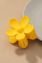 Dreamin' of Daisies? Well, throw on this precious classic hair clip to add an instant and effortless pop of color to any look. Classic claw style meets totally trendy retro daisy design.  100% Acrylic Measures about 3" Classic claw design