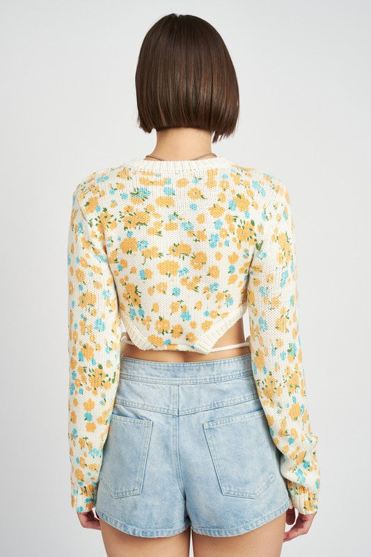 Sunsets in spring and all thing serene in this precious floral sweater! Featuring a cropped silhouette, classic crew neckline, and anything-but-classic cutouts at the waist with functional drawstring details to perfectly cinch it all together. An instant team-favorite and the perfect pre-spring transition piece.