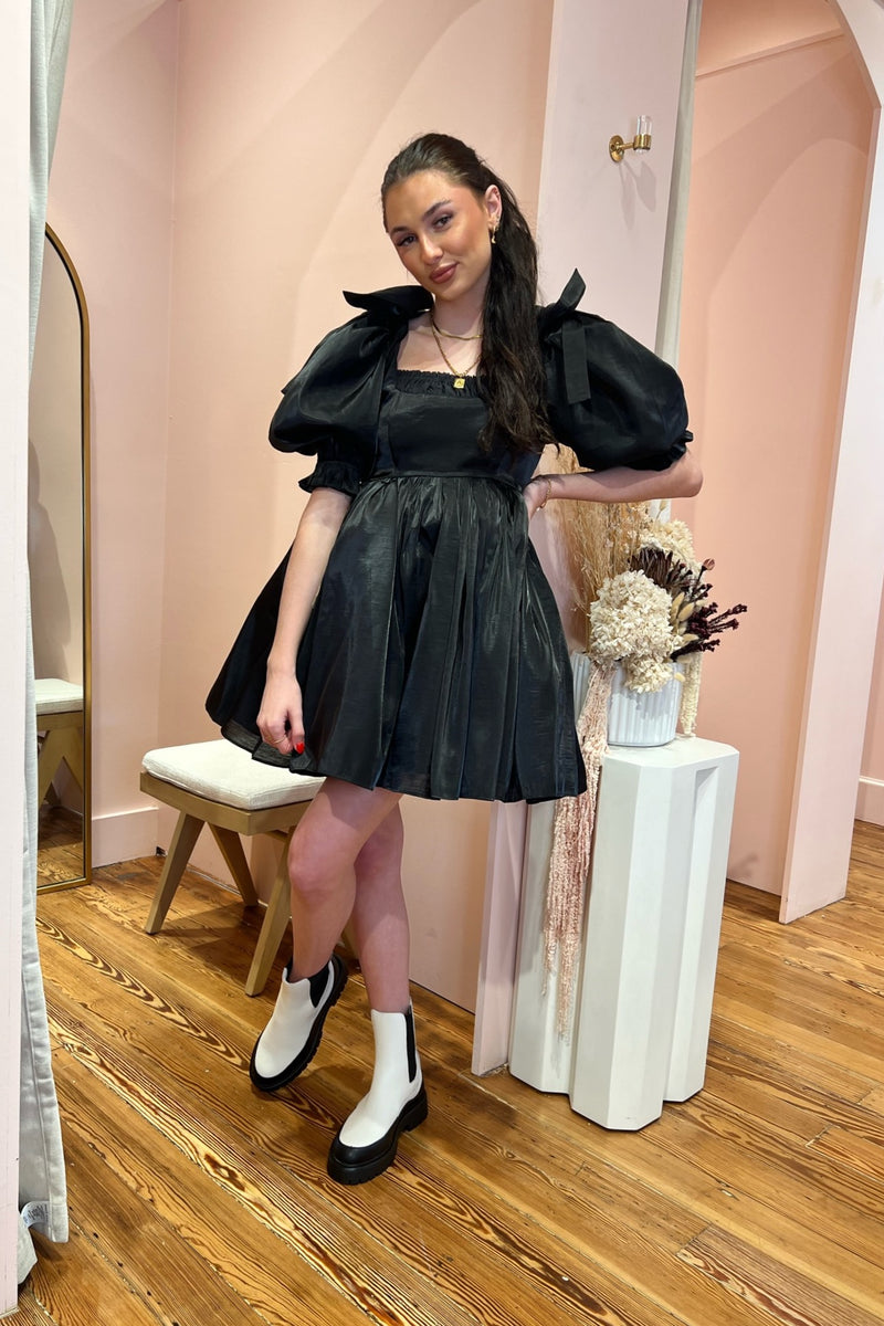 A gothic romance in raven hues, dark dreams alight with the Caviar Da Vinci Puff Dress. Dramatic bow-bedecked puff sleeves echo the short puff skirt, while gathers at the neckline draw the eye. Wear this to your ex’s wedding, or funeral, or dancing under the moonlight. 