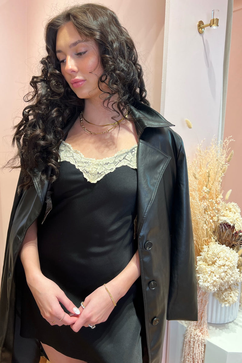 Oops, made you look in the dreamiest mini slip dress! Designed for off-duty days that seamlessly lead into flirty nights, this flattering bias-cut, soft and slinky mini is the year-round LBD slip you'll be going back to for years to come. Topped off with a romantic lace detailing and an eye-catching low back, guaranteed to have them doing double takes. Paired here with our Sweet and Southern Embroidered Boot, City Never Sleeps Vegan Leather Trench, and Stay A While Turtleneck Sweater.