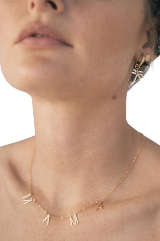 The Mamas in your life deserve this precious banner necklace, or maybe you are that Mama! With its' letters suspended on its' thin gold chain, this piece is perfect for everyday wear and can be layered with your other favorites.  14K Gold Filled Handmade in Costa Mesa, CA. Measures 14" with 2" extender 