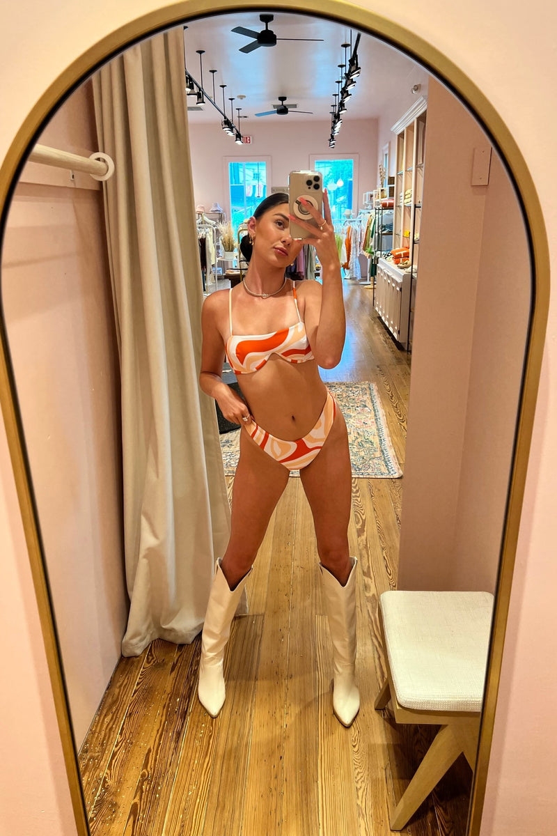 Let's face it, we've got a major orange crush on this stunning underwire bikini set! With a playful print in a perfect summer sunset color scheme, the top features a modern twist on the classic, supportive underwire and the bottom is a figure flattering, high cut, seamless stunner that sits right above the hips.