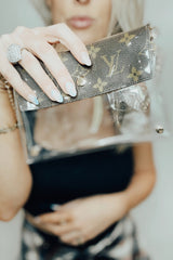 You know you need me. These stadium approved clear bags can be worn as a fanny pack or crossbody and feature an upcycled patch from luxury handbags!  8.5 in x 6.7 in (fits iPhone Pro Max)  Authentic upcycled material from luxury handbags Clear bag policy approved for any and all concerts, games, and indoor arenas 