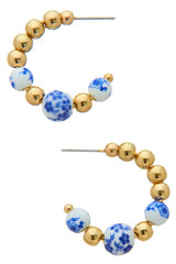 Elegant and classic, but with a playful pop of color... these delft flower beaded C-hoops are the modern twist on the classic hoop that we've been waiting for!  Measure ~ 1" long Sold as a set Open C-Hoop earrings