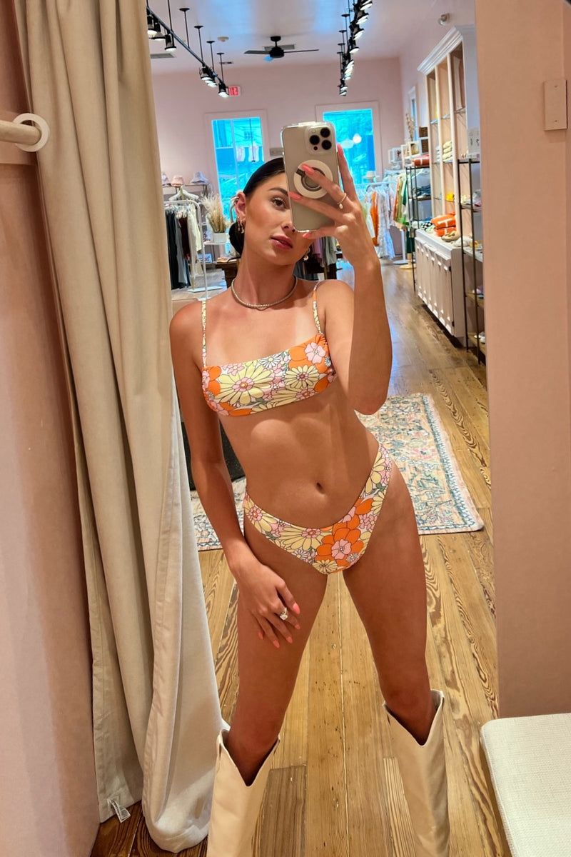 Tangerine dreams do come true and this stunning tie back bandeau bikini set is living proof! With a flattering and completely adjustable bandeau top that'll keep you perfectly in place from poolside to pool bar, and V-cut bottoms that hit high on your hips, this seamless duo will be a guaranteed go-to for years to come.