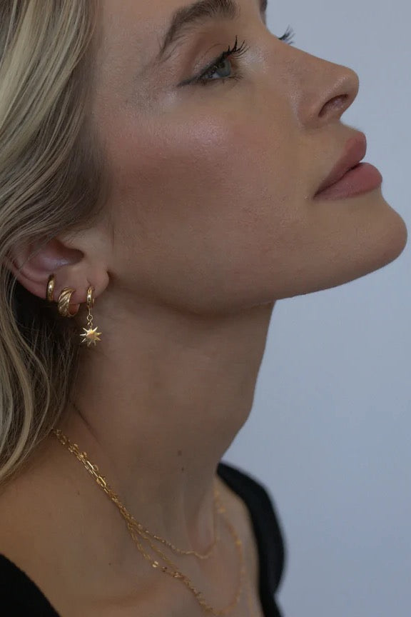 Let's face it... these gold filled Nova Charm Hoops are simply out of this world! With original star charms and a classic huggie hoop style, these stackable gems add an effortless pop of glam to your everyday jewelry assortment.  Sold as a set Gold Filled Handmade in Costa Mesa, CA.