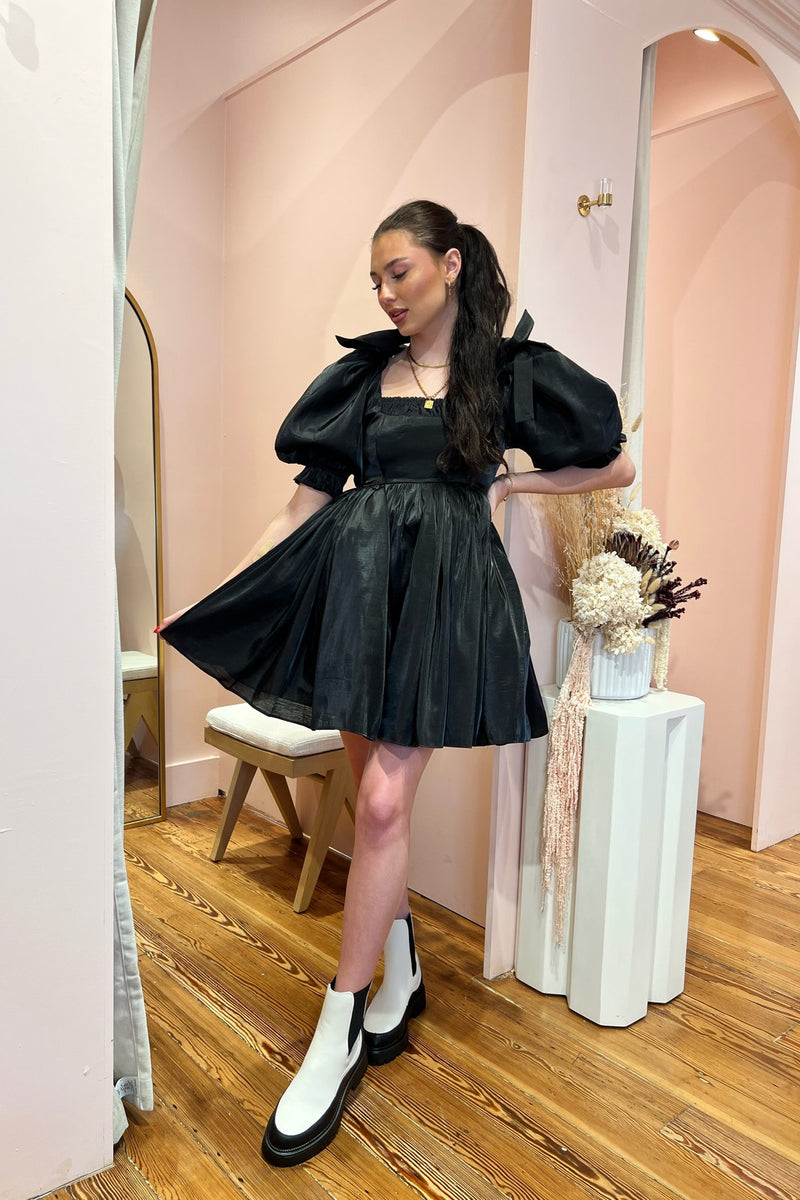 A gothic romance in raven hues, dark dreams alight with the Caviar Da Vinci Puff Dress. Dramatic bow-bedecked puff sleeves echo the short puff skirt, while gathers at the neckline draw the eye. Wear this to your ex’s wedding, or funeral, or dancing under the moonlight. 