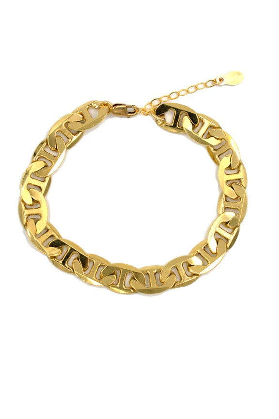 Intricate and elegant, we could not be more obsessed with this stunning Cuban Chain Bracelet! Guaranteed to be a piece you're loving for years to come.  Bold Cuban style chain bracelet Thick Gold Overlay Measures 6.5" with 1" extender chain Handmade in Costa Mesa, CA.