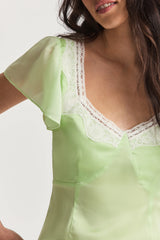 For the flirty and feminine, our Aubrietta Dress from LoveShackFancy makes its dreamy debut. This romantic mini is designed with a solid iteration of combining chiffon fabric with custom contrasting lace on our whimsical charmeuse fabric. Lace highlights the dress outlining an open square scoop neck and lining the hem around a beautiful slit. The piece has playful flutter sleeves for a light and airy feel. 