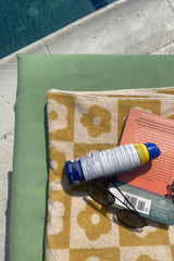 Get ready to Vacay Away and make sure you bring this precious beach towel! Featuring ultra absorbent, water wicking cotton material, a resort size and on-trend playful print, this essential vacation staple is meant to be loved for years to come.  100% Cotton Measures 70 x 140 CM Multi = floral print checkered design Check = solid checkered design