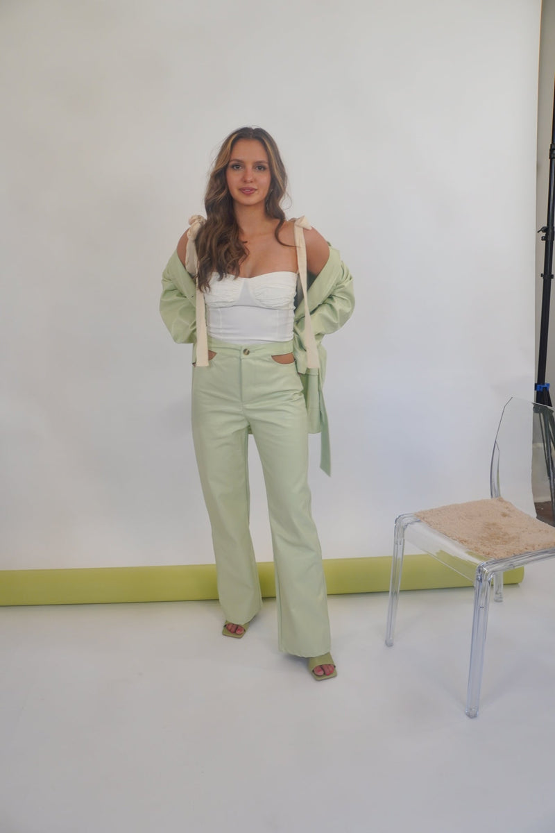 This bustier top is TRULY what our dreams are made of! With its' corset silhouette and ribbon tie sleeves, it doesn't get much more romantic than this. Our What Dreams are made of Bustier is shown here with our Minty Fresh Cutout Pant, Jacket and Fair and Square Mule.  Runs true to size, model wearing size small 95% Polyester, 5% Spandex Partially lined