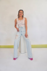 Throw me on and away you go! These wide leg distressed jeans will be by your side through it all. With their high rise, relaxed fit and distressing at the thighs, these are the perfect boyfriend jeans to accompany any of your favorite crop tops. Shown here with our Heard it through the Grape Vine Corset Top and Think Pink Mule.