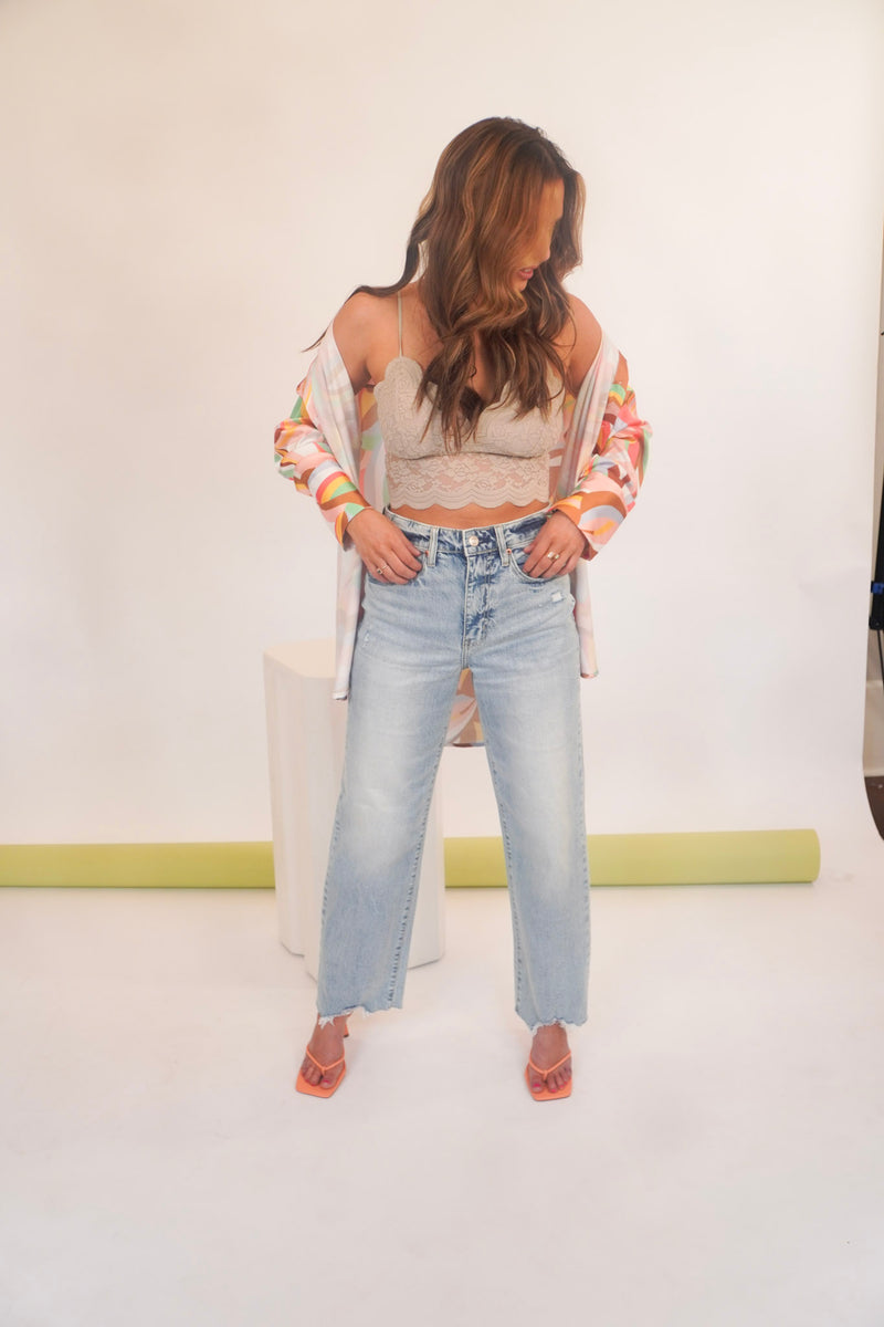 They don't make them like this anymore, until now. The Pleaser is a straight leg jean  in organic cotton with an eco-friendly wash process. Fits relaxed from the high rise to the ankle-length hem. Finished with a zipper fly and 5 pockets. Our Pleaser High Rise Jean is styled here with our Little & Lace Cami, Work of Art Button Down, and Be My Clementine Mule.