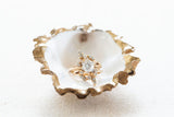 These elegant gilded oyster jewelry dishes are a beautiful nautical accent for your home, and better yet, they give back! Grit and Grace recycles ten oyster shells for each oyster ring dish sold. The beautiful packaging reads, “The World Is Your Oyster!” with a scripted message on the inside of their eco-friendly box, which also contains 100% recycled crinkle paper.