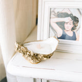 Celebrate the coast by adding these oyster shell candle to your nautical centerpieces and coastal decor. These hand-poured soy wax candles are housed in Grit and Grace Studio's trademark gilded oyster shell dishes, making them an eye-catching, luxurious addition to your home decor. Give an oyster shell candle - or three! - to the ones you hold closest.