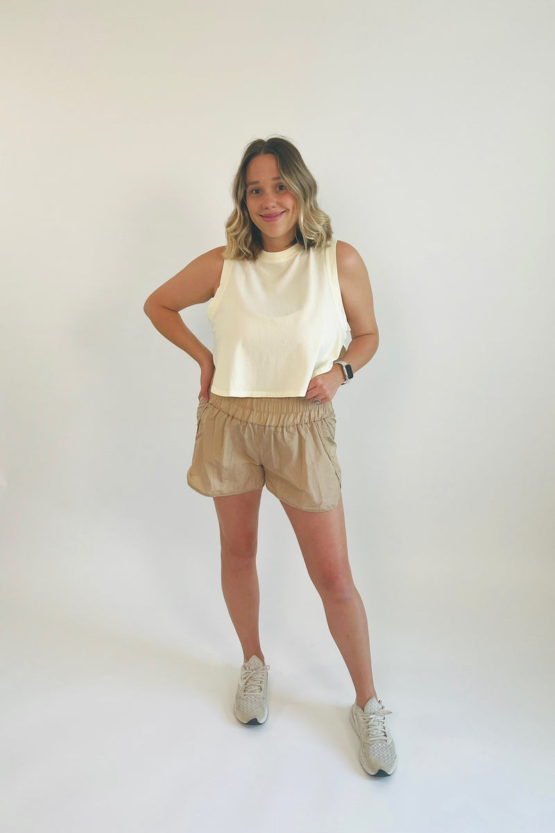 Take a break in these perfectly precious and totally on trend smocked windbreaker shorts! Ultra lightweight, breathable and born for anything and everything from working out to your day out, these are truly the active shorts of the season! Paired with our Prim and Proper Ruffle Sports Bra and Less is More Side Slit Tank.  Runs a little small, Bonnie is 5'5" wearing size large 100% Nylon Side slit High Waist Brief lining