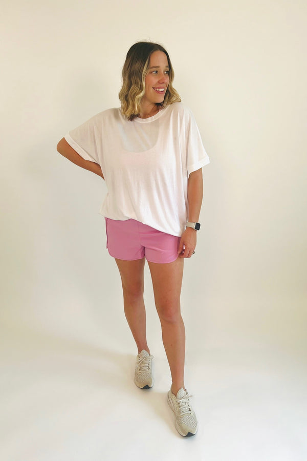Stay active, stay comfy in this perfect smocked elastic short! The trend of the season that's sure to stick around for years to come, these versatile and lightweight shorts will be there for you from workout to your day out. Shown here with our Go Long Tie Back Top.  Runs true to size, model wearing size small & Alana in size small 95% Polyester, 5% Spandex Side slit High Waist Brief lining