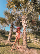 Groove with me... this bikini set is almost as fun as summer! Featuring a throwback, pop of color, playful print, metal V-shape detail at bust, and high-cut, v-shaped bottoms, this flattering duo is made for days filled with fun in the warm summer sun.