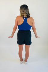 If loungewear and activewear could be perfectly blended into one, it'd be these Hot Shot High Waist Shorts! Constructed using moisture-wicking, four-way stretch fabric and has a relaxed cut and feel for all day long comfort. It features a drawstring closure with a cord locker as well as side pockets. Shown here with our At Ease Ribbed Racerback Tank and Go Long Tie Back Top.