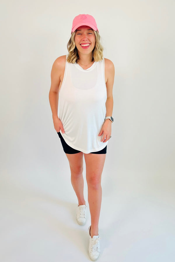 Totally raw and real, this flow tank is made for getting down to business! A curved hem and raw edges on the collar and sleeve holes make this the perfect tank to throw on for a walk or your next yoga session. Shown here with our Essentials Only Biker Short.  Runs a little big, Bonnie is 5'5" wearing size large 95% Rayon, 5% Spandex Curved hem Loose fitting and stretchy material  Raw edges at collar and sleeve holes