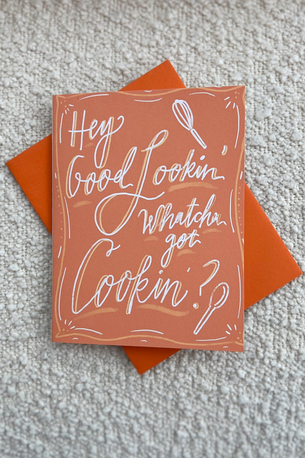 Hey good lookin... whatcha got cookin? Let that special someone know you're thinking of them with this precious, hand-drawn greeting card! Perfect for any occasion, or just to say hello.  Hand-drawn design Made with love in Houston, TX. Blank inside