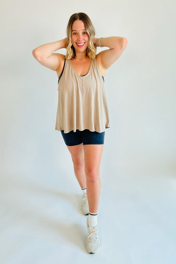 You're self made and used to working hard, and this sporty strap back tank will ensure you're effortlessly cool and put together for even the toughest of workouts! Crafted from cotton-modal-blend fabric, this loose-fitting top also features a V neckline, a seamline in the front middle, and a horizontal strap on the back. Shown here layered over our Just Breathe Seamless Onesie.