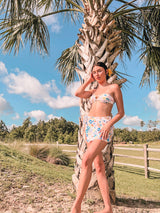 Made for catching sun rays and being transported to a sun filled daze, this bandeau bikini set was created for minimal tan lines and lots of good times. Classic strapless bandeau style top and high cut, minimal coverage tie side bottom. Pairs perfectly with our Floral Sarong.