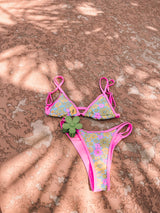 With all the colors of summer, this supportive and flattering retro print triangle bikini set is guaranteed to be an instant favorite in your swimmie collection! With a neon pink contrast lining, double strap detail at the shoulders and hips, and allover vintage-inspired floral print, this fun-loving duo will be there for you all summer long.