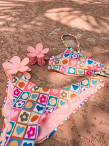 As the queen of hearts, wear your heart on your sleeve and also on your bikini! This precious, retro-printed swimmie is as playful as can be and made for everything the summer holds. Featuring a supportive, sport-friendly top and adjustable straps and a flattering, minimal coverage ruched bottom, this dynamic duo is an instant favorite. 