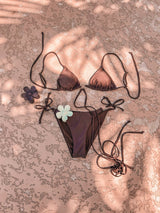 A little wild at heart, this strappy, tie bikini is our new go-to staple for the summer! Featuring metal heart decals at the bust and hips, a classic, adjustable triangle top and side-tie bottom and an edgy and sultry tie detail, this duo gets better as the days get longer.