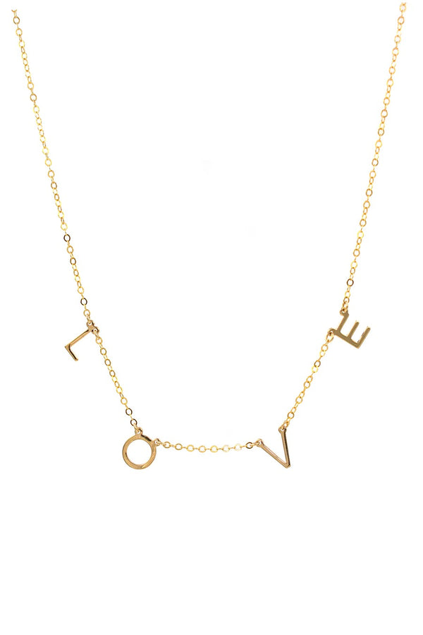 We could not be more in love with this precious banner necklace! With its letters suspended on its thin gold chain, this piece is perfect for everyday wear and can be layered with your other favorites.  Gold Filled Handmade in Costa Mesa, CA. Measures 14" with 2" extender 