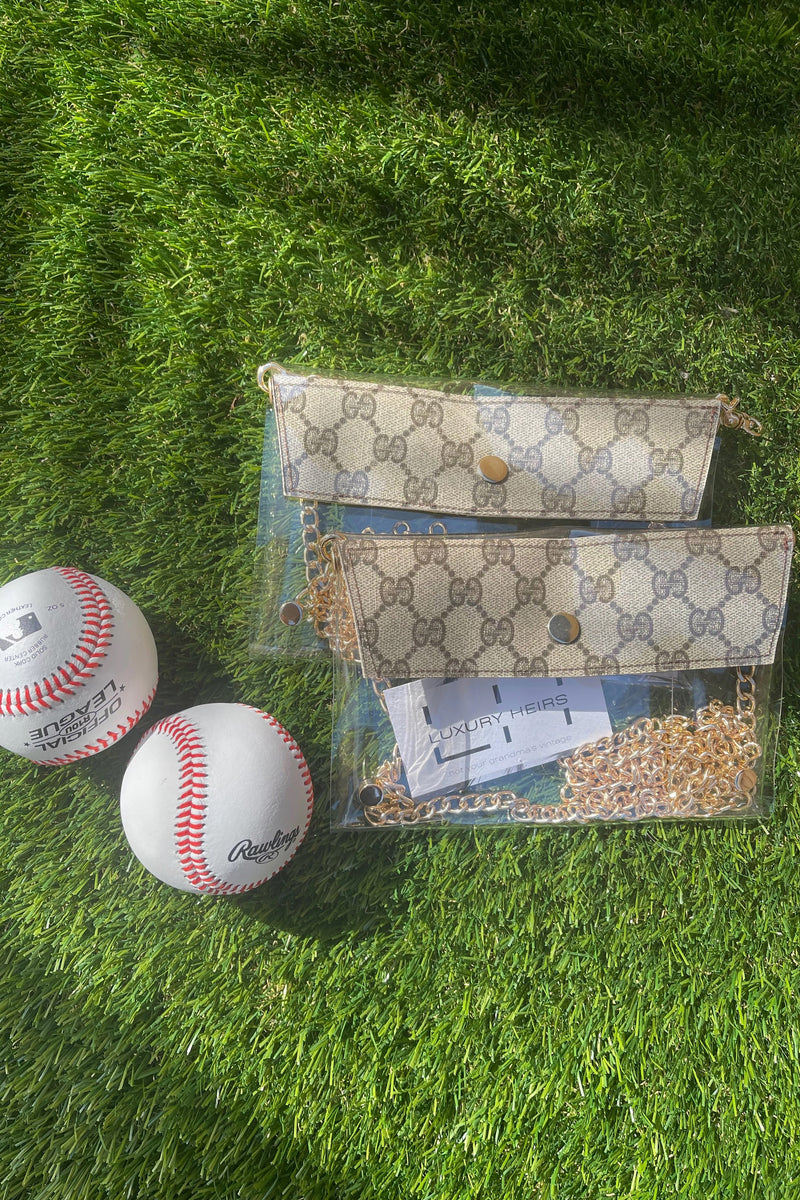 You know you need me. These stadium approved clear bags can be worn as a fanny pack or crossbody and feature an upcycled patch from luxury handbags!  8.5 in x 6.7 in (fits iPhone Pro Max)  Authentic upcycled material from luxury handbags Clear bag policy approved for any and all concerts, games, and indoor arenas 