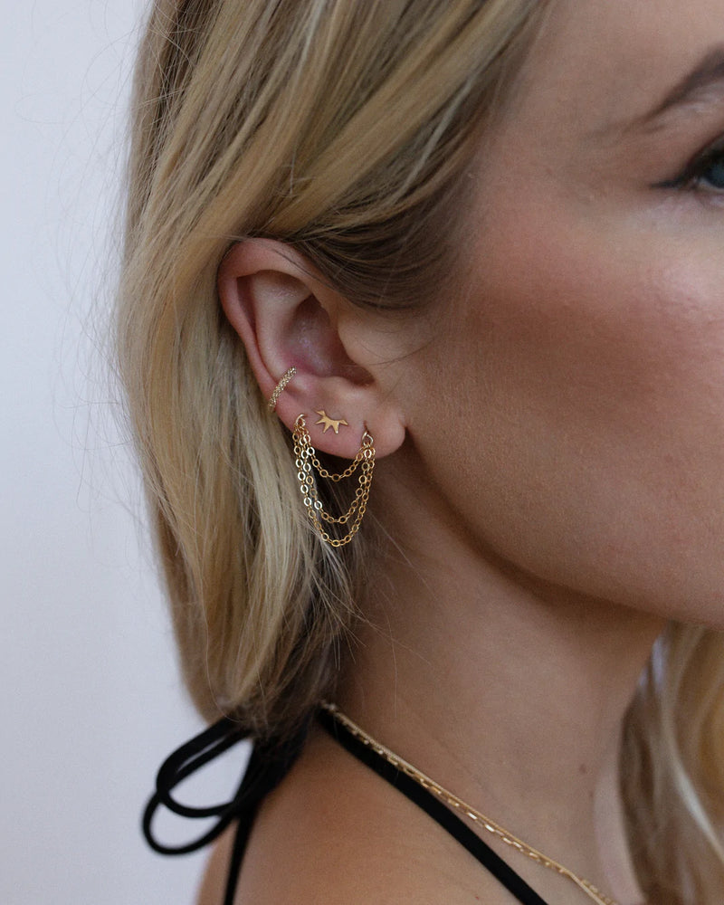Tis the season for all things glitz and glam, and we all know there's no way to spice up any festive Holiday ear party than with a stunning ear cuff! Pop it on and you're good to go, or layer a few for extra edge. Pairs perfectly with the matching Glitzy Huggies, or stuns with our Cascade Hoops and Ray Studs (shown here). Sparkly little ear cuff Gold Filled or Sterling Silver. Handmade for you in our Costa Mesa, CA studio.