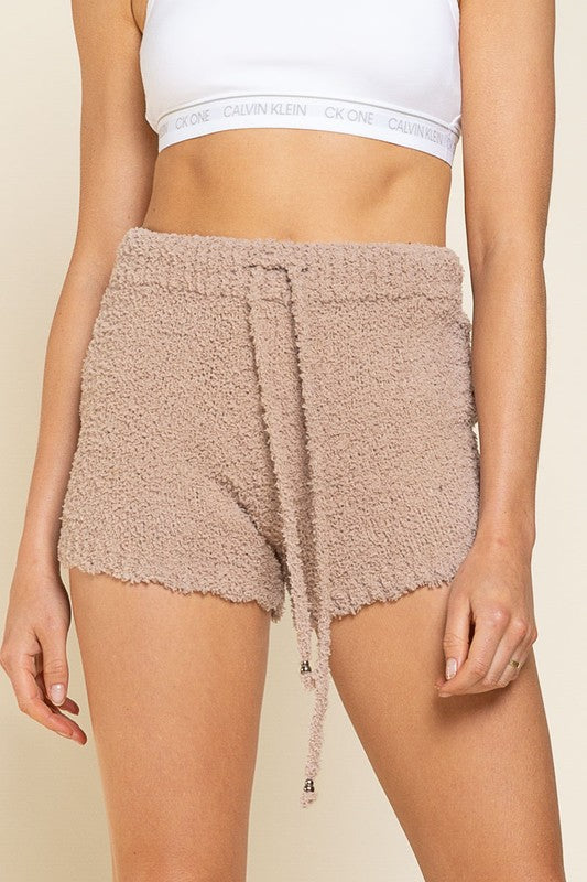 It's all in the name... you'll be living in these perfect berber fleece lounge shorts! Featuring an adjustable waist drawstring, these gems are just too soft (and cute) to be true. Seriously, you've gotta feel 'em to believe it! Pair it with our Never Take Me Off Hoodie to be the comfiest you've ever been.  Runs true to size, model wearing size small 100% Polyester Matching item available