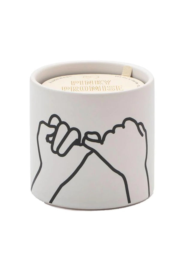 Pinky promise! Express yourself with these colorful matte ceramic candles. Each candle comes with a gold foil stamped dust cover with a fun sentiment to share with the people you love. *In Store Pickup Only* Top Notes: Bergamot, Fig, Bay Leaf, Citrus Zest, Pomelo Middle Notes: Rose, Vetiver, Green Tea, Pink Pepper, Carnation Base Notes: Cedar, Sheer Spices, Hay, Musk, Patchouli, Guaiac Size: 5.75 oz. Vessel: Ceramic Dimensions: 3.125" L x 3.125 " W x 3 " H